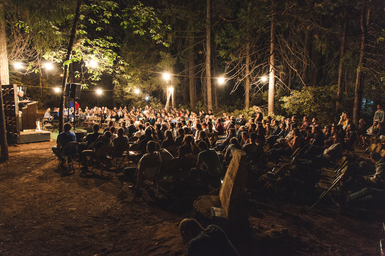 A nighttime gathering under glowing string lights
