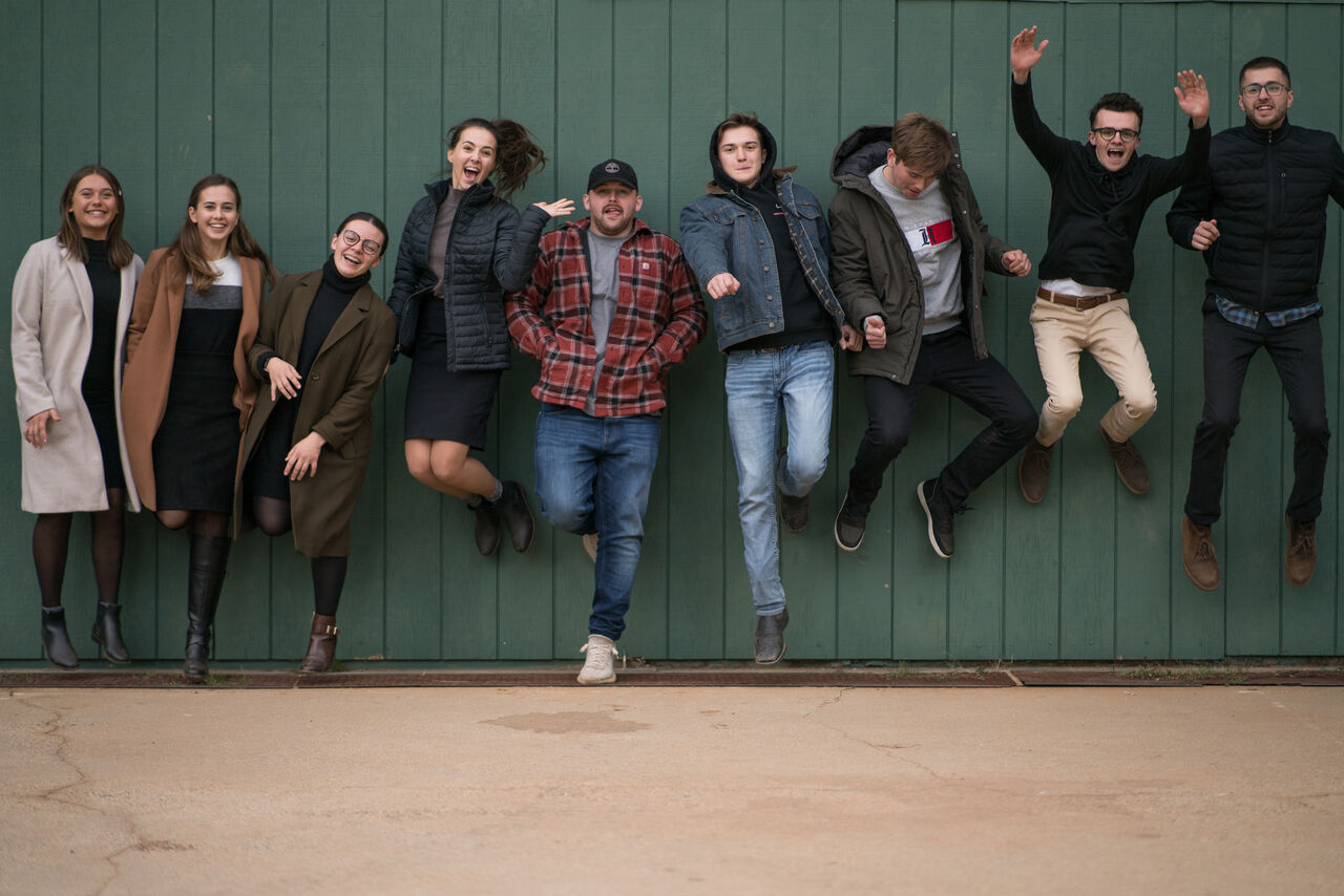 A group of friends jumping together for a photo
